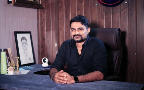 Professional at desk with 'Master Services' branding in a well-appointed office.